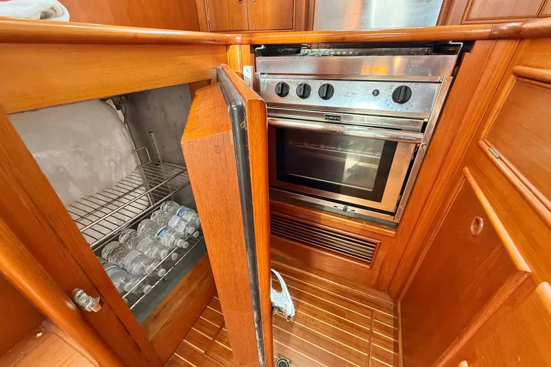 Slide: The Image of Galley of 1999 Grand Banks 38 Eastbay EX with oven and open fridge. - 23