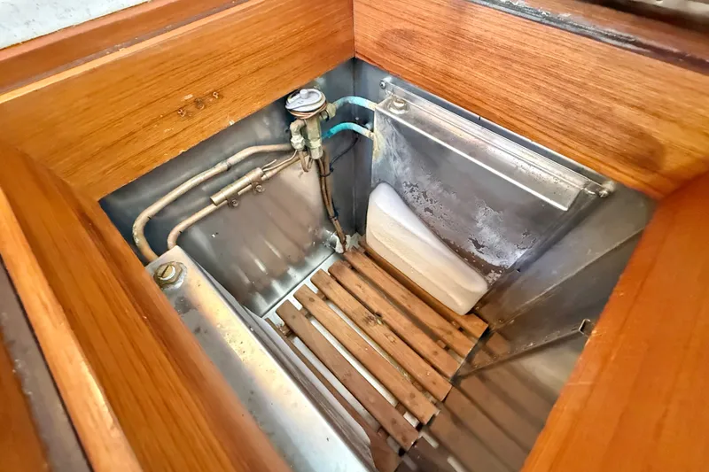 Slide: The Image of Bilge area of 1999 Grand Banks 38 Eastbay EX with wooden slats and metal pipes. - 26