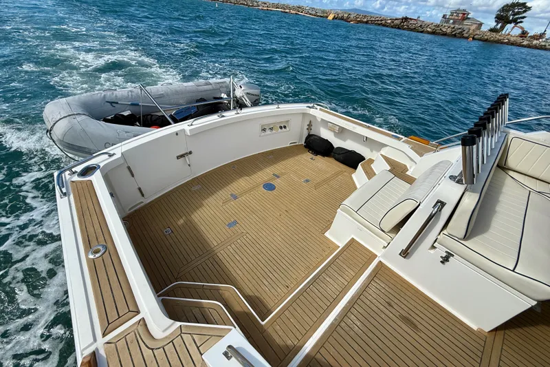 Slide: The Image of 1999 Grand Banks 38 Eastbay EX yacht deck with tender on ocean. - 9