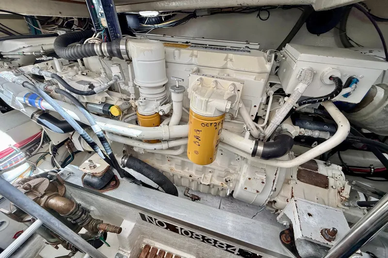 Slide: The Image of Engine compartment of a 1999 Grand Banks 38 Eastbay EX boat, showcasing detailed machinery. - 42