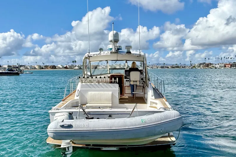 Slide: The Image of 1999 Grand Banks 38 Eastbay EX yacht on calm water under a cloudy sky. - 7