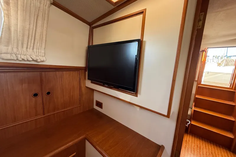 Slide: The Image of Interior of 1999 Grand Banks 38 Eastbay EX with TV and wooden cabinetry. - 34