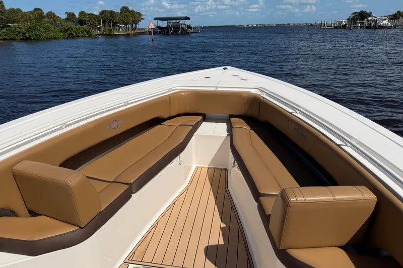 Slide: The Image of 2021 Fountain 38 CC LS boat with tan seating, docked on a sunny day. - 8