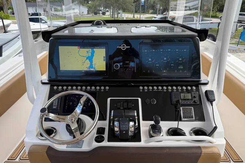 Slide: The Image of 2021 Fountain 38 CC LS boat dashboard with navigation screens and controls. - 2