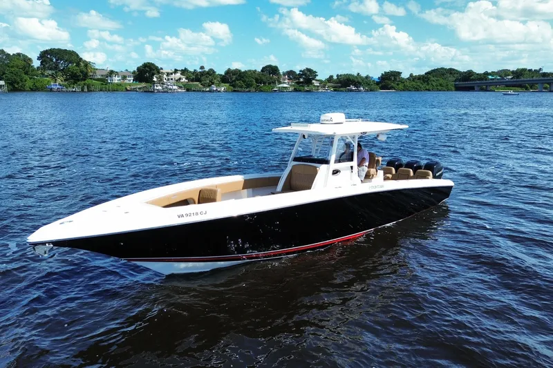 Slide: The Image of 2021 Fountain 38 CC LS boat cruising on a sunny day with scenic background. - 4