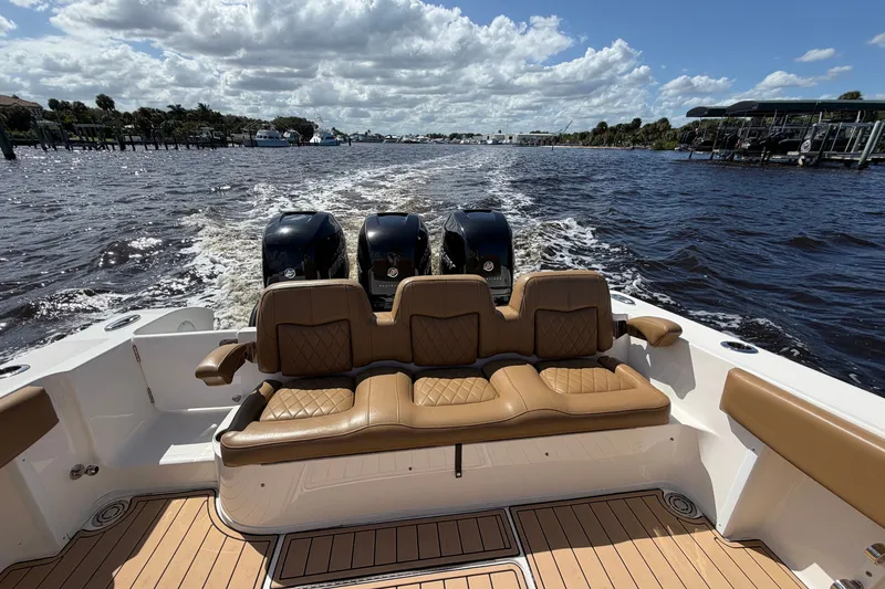 Slide: The Image of 2021 Fountain 38 CC LS boat with triple engines cruising on a sunny day. - 25