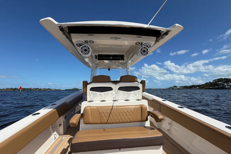 Slide: The Image of 2021 Fountain 38 CC LS boat interior with seating, speakers, and ocean view. - 11