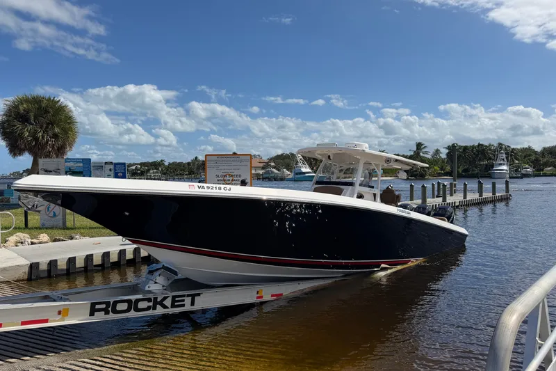 Slide: The Image of 2021 Fountain 38 CC LS boat on trailer at marina under blue sky. - 6