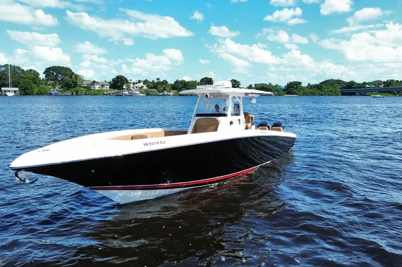 The Image of 2021 Fountain 38 CC LS boat on a sunny day, cruising on a scenic river. - 0