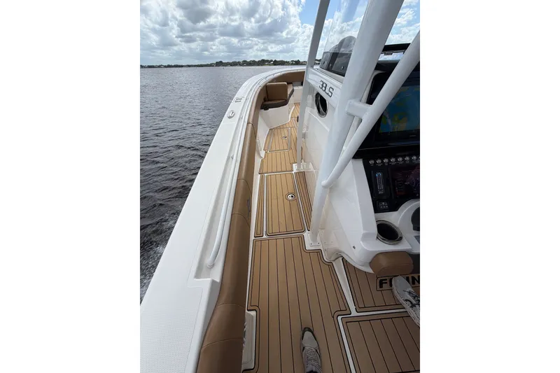 Slide: The Image of 2021 Fountain 38 CC LS boat interior with teak flooring and control panel. - 18