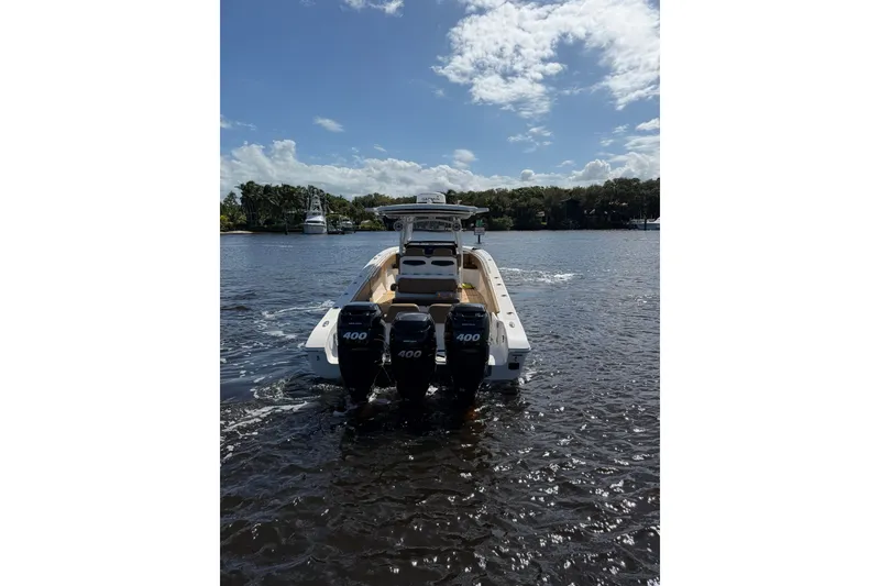 Slide: The Image of 2021 Fountain 38 CC LS boat with triple 400 engines on a sunny day. - 3