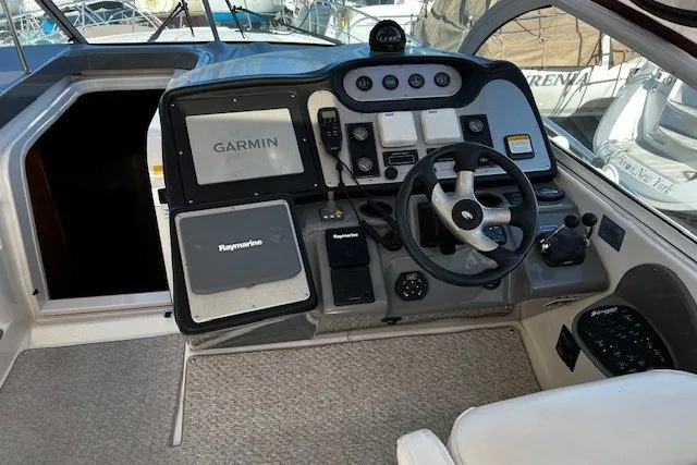 Slide: The Image of 2005 Cruisers Yachts 440 Express helm with Garmin and Raymarine navigation systems. - 3