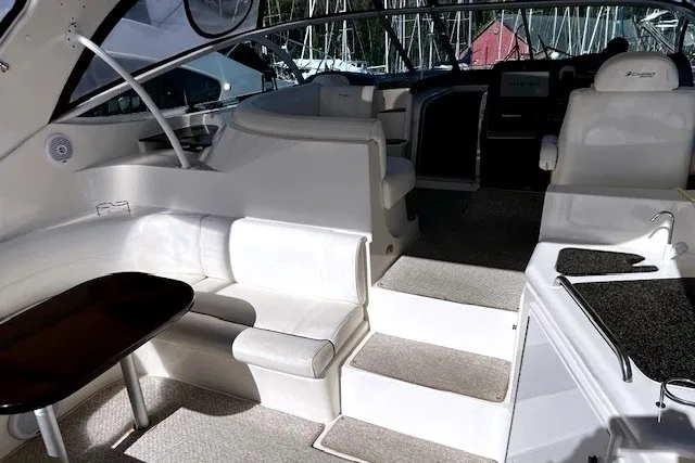 Slide: The Image of Interior of 2005 Cruisers Yachts 440 Express, featuring white seating and modern amenities. - 13