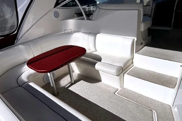 Slide: The Image of 2005 Cruisers Yachts 440 Express interior with white seating and red table. - 14