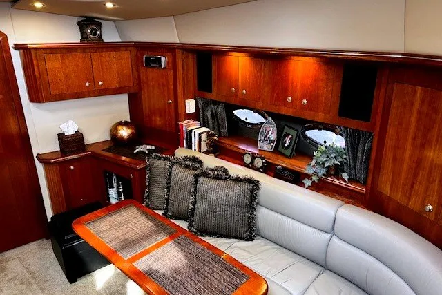 Slide: The Image of Luxurious 2005 Cruisers Yachts 440 Express interior with elegant wood cabinetry and plush seating. - 4