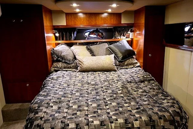 Slide: The Image of Luxurious bedroom interior of 2005 Cruisers Yachts 440 Express with elegant bedding and wood accents. - 9
