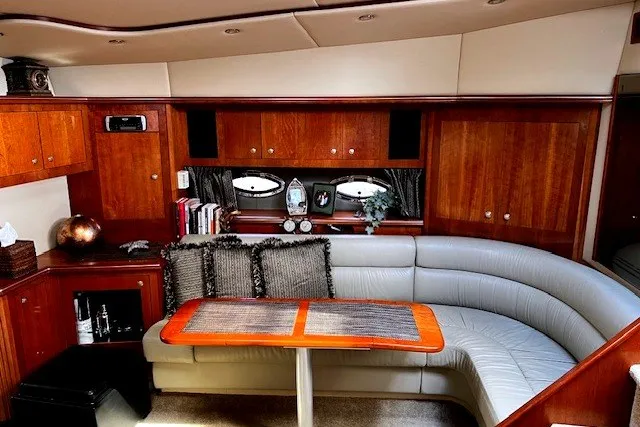 Slide: The Image of Luxurious 2005 Cruisers Yachts 440 Express interior with elegant wood finish and plush seating. - 6