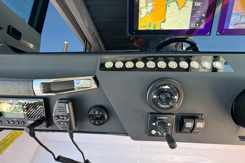 Slide: The Image of 2024 Axopar 29 XC Cross Cabin dashboard with navigation controls and display screens. - 18