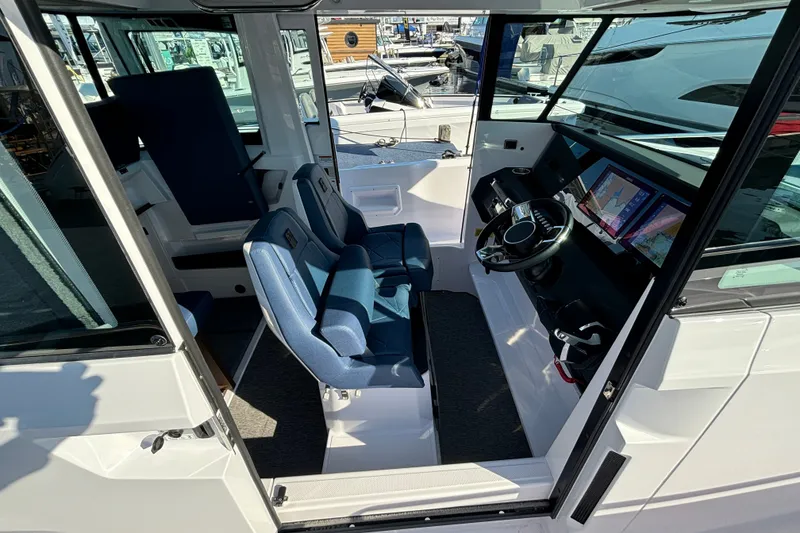 Slide: The Image of 2024 Axopar 29 XC Cross Cabin interior with modern dashboard and seating. - 15