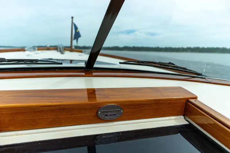 Slide: The Image of 2007 Hinckley Talaria 29R boat dashboard with wooden trim and scenic water view. - 8