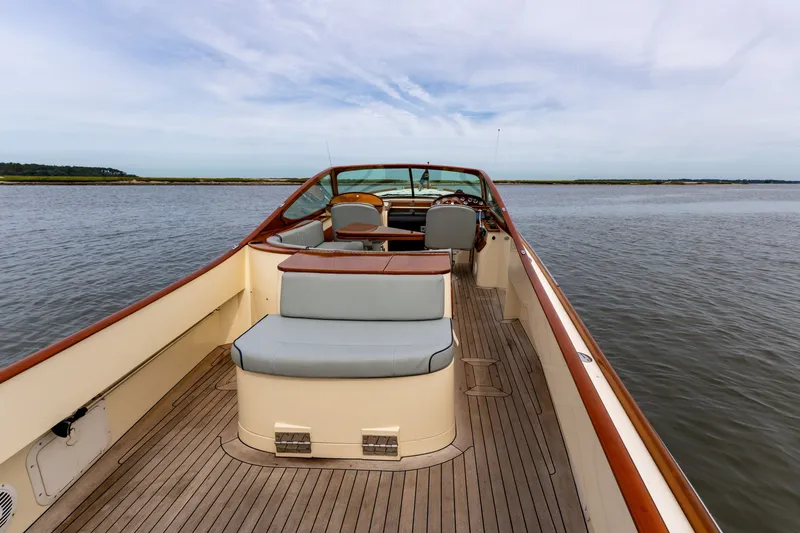 Slide: The Image of 2007 Hinckley Talaria 29R boat interior with wooden deck, cruising on calm waters. - 11