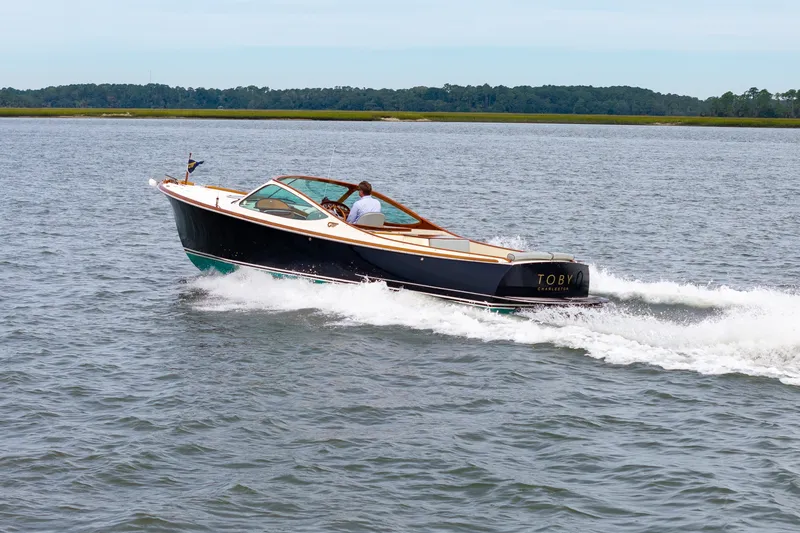 Slide: The Image of 2007 Hinckley Talaria 29R cruising on open water. - 26