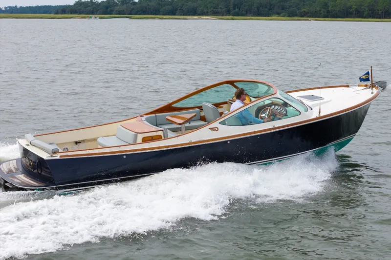 Slide: The Image of 2007 Hinckley Talaria 29R cruising on open water, showcasing elegant design and craftsmanship. - 24