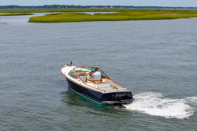 Slide: The Image of 2007 Hinckley Talaria 29R cruising on a serene waterway. - 23