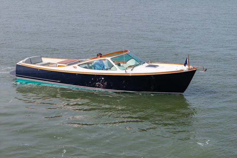 Slide: The Image of 2007 Hinckley Talaria 29R boat cruising on calm water. - 2