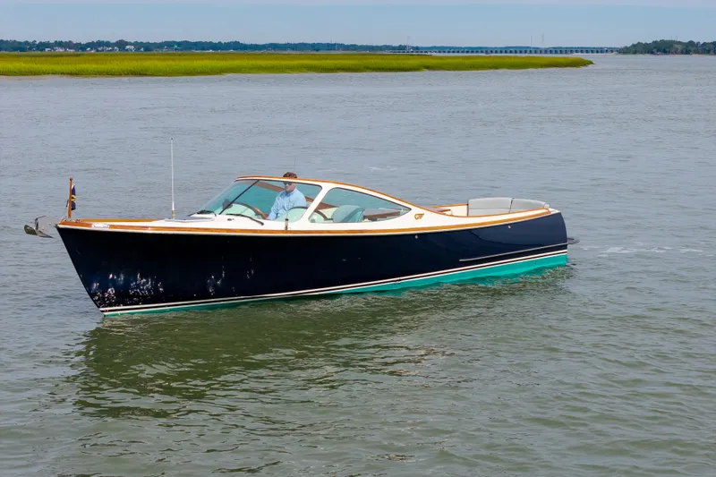 Slide: The Image of 2007 Hinckley Talaria 29R boat cruising on calm waters. - 17