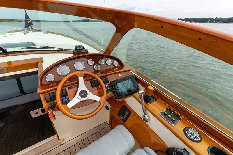 Slide: The Image of Helm of 2007 Hinckley Talaria 29R boat with wooden dashboard and steering wheel. - 5