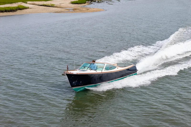 Slide: The Image of 2007 Hinckley Talaria 29R cruising on open water, creating a wake behind. - 27