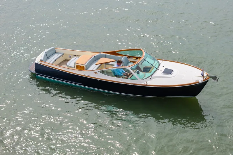 Slide: The Image of 2007 Hinckley Talaria 29R boat cruising on calm water, featuring elegant design and spacious seating. - 21