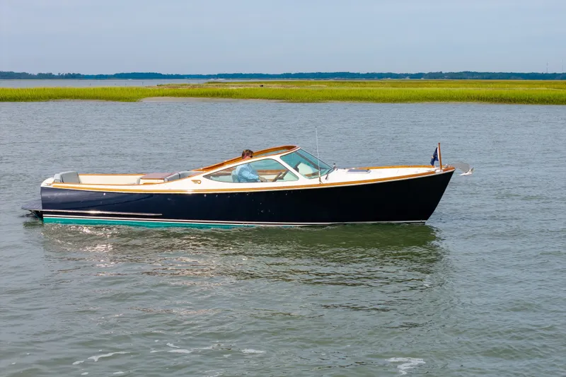 Slide: The Image of 2007 Hinckley Talaria 29R cruising on calm waters with scenic marshland backdrop. - 20