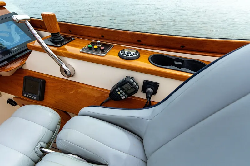 Slide: The Image of 2007 Hinckley Talaria 29R cockpit with navigation controls and leather seating. - 6