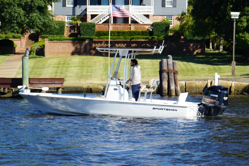 The Image of 2017 Sportsman Tournament 214 Bay Boat cruising on a river near a residential area. - 0
