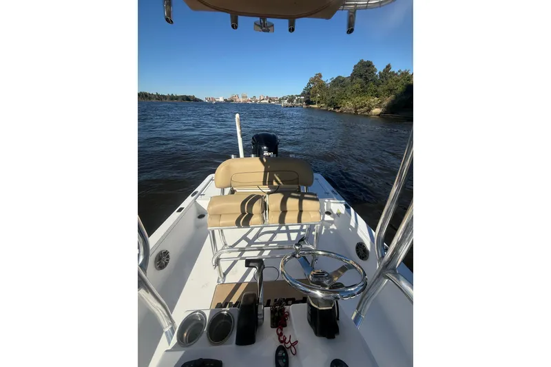 Slide: The Image of 2017 Sportsman Tournament 214 Bay Boat on water, featuring helm and seating. - 24