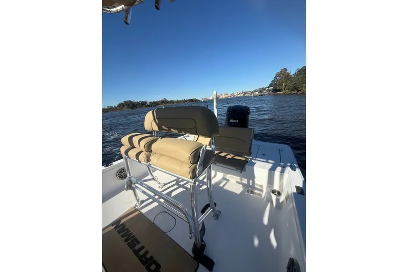 Slide: The Image of 2017 Sportsman Tournament 214 Bay Boat on water, featuring seating and outboard motor. - 15