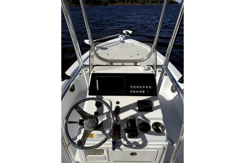 Slide: The Image of 2017 Sportsman Tournament 214 Bay Boat dashboard with steering wheel and controls on water. - 14
