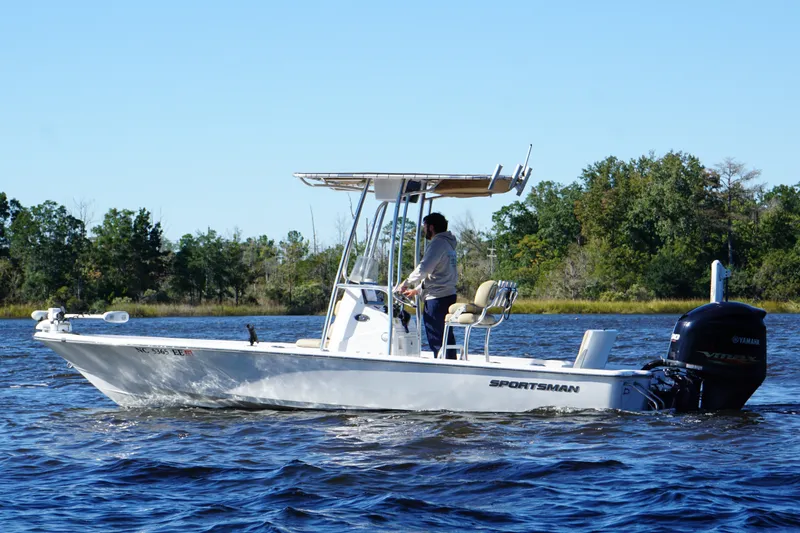 Slide: The Image of 2017 Sportsman Tournament 214 Bay Boat cruising on a scenic lake with trees in the background. - 11