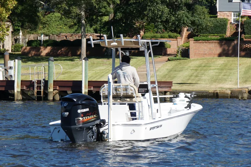 Slide: The Image of 2017 Sportsman Tournament 214 Bay Boat on water, Yamaha engine, near dock and landscaped yard. - 18