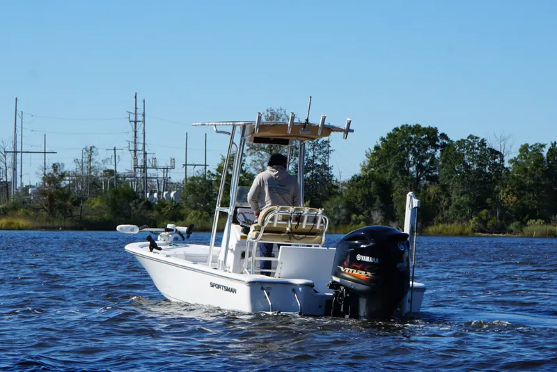 Slide: The Image of 2017 Sportsman Tournament 214 Bay Boat cruising on a river with trees in the background. - 19