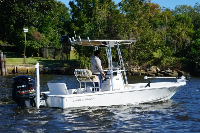 Slide: The Image of 2017 Sportsman Tournament 214 Bay Boat cruising on a scenic river. - 2