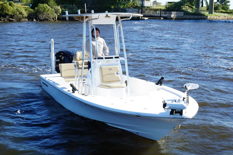 Slide: The Image of 2017 Sportsman Tournament 214 Bay Boat cruising on a river with a person at the helm. - 7