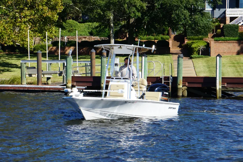 Slide: The Image of 2017 Sportsman Tournament 214 Bay Boat cruising near a dock on a sunny day. - 3