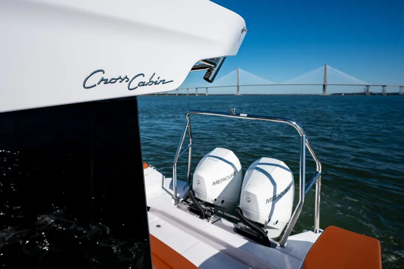 Slide: The Image of 2026 Axopar 29 XC Cross Cabin boat with dual Mercury engines on open water. - 14