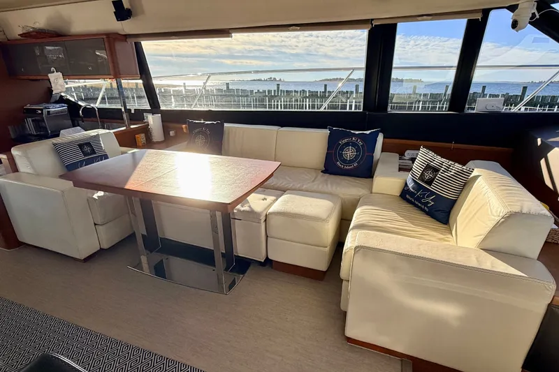 Slide: The Image of Luxurious interior of 2014 Prestige 620 yacht with white seating and scenic window view. - 25