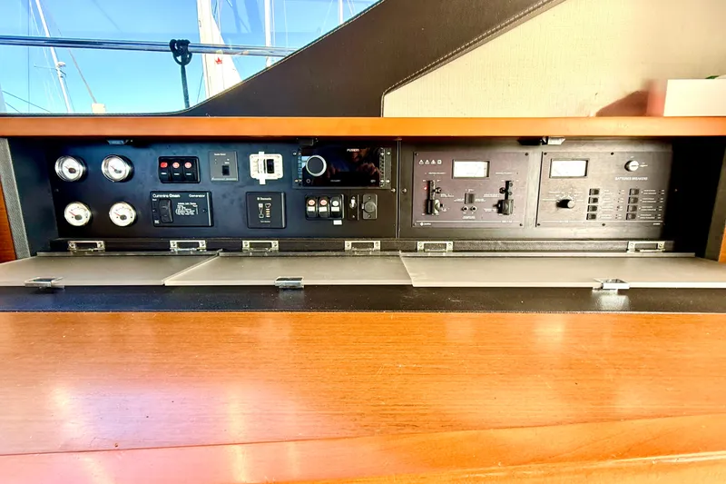 Slide: The Image of Control panel of a 2014 Prestige 620 yacht with various switches and gauges. - 54