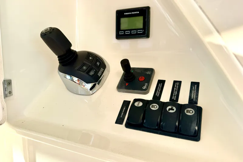 Slide: The Image of Control panel of a 2014 Prestige 620 yacht with joystick and switches. - 17