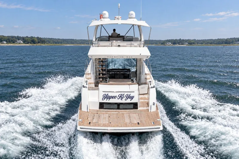 Slide: The Image of Luxury 2014 Prestige 620 yacht cruising on open water, rear view. - 4